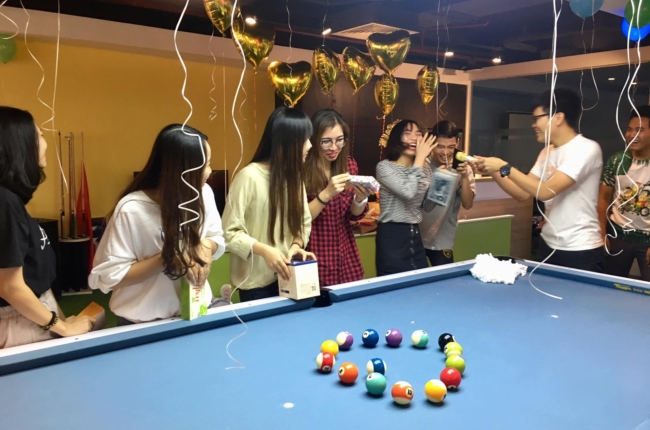 Rises team event around a pool table